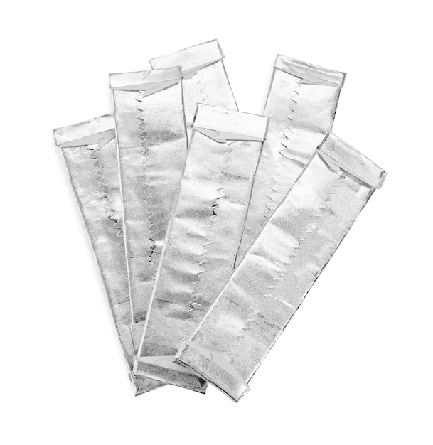 Sticks of tasty chewing gum wrapped in foil isolated on white top view