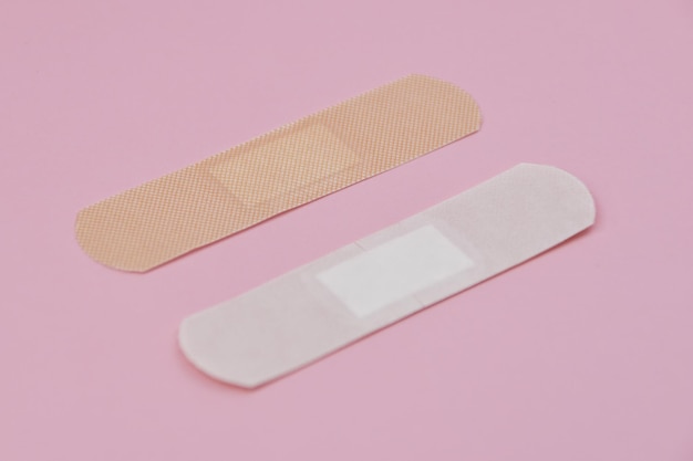 写真 ピンクの背景のヘルスケアコンセプションに貼り付ける医療パッチ