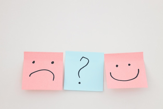 Sticky note face smile and sad on wall emotion paper