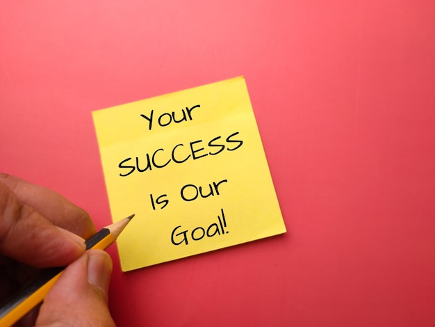 Photo sticky note and pencil with the word your success is our goal