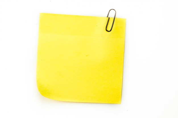 Sticky note with grey paperclip against a white background