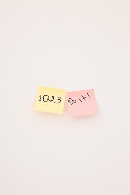 A sticky note with the year 2023 on white wall Close up New year New chance