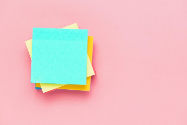 Photo sticky paper notes on pink background for office and school stationary concept