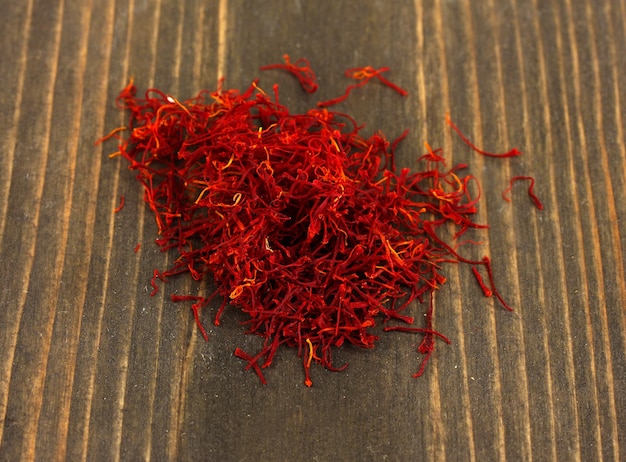 stigmas of saffron on wooden background closeup