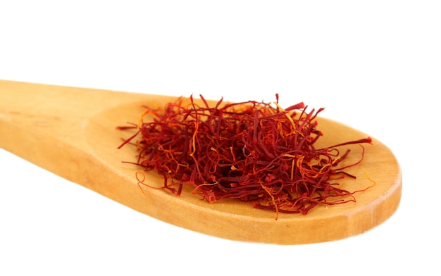 Stigmas of saffron in wooden spoon close-up