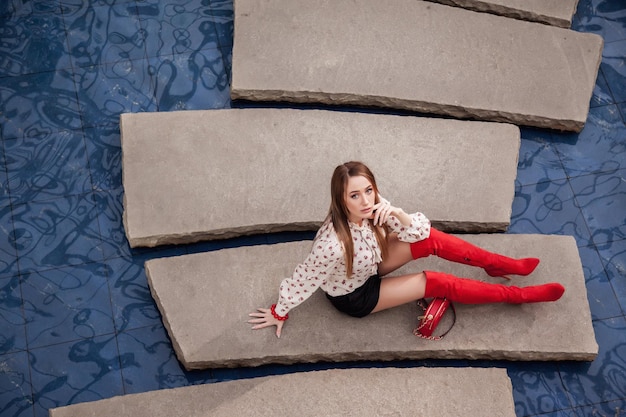 Stijlvolle brunette poseert professioneel voor de camera op zijn plaats eiland aan blauw water