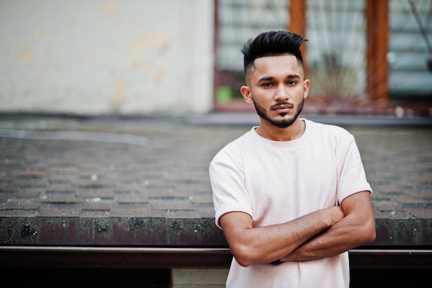 Stijlvolle Indiase baardman bij roze t-shirt India-model poseerde buiten in de straten van de stad