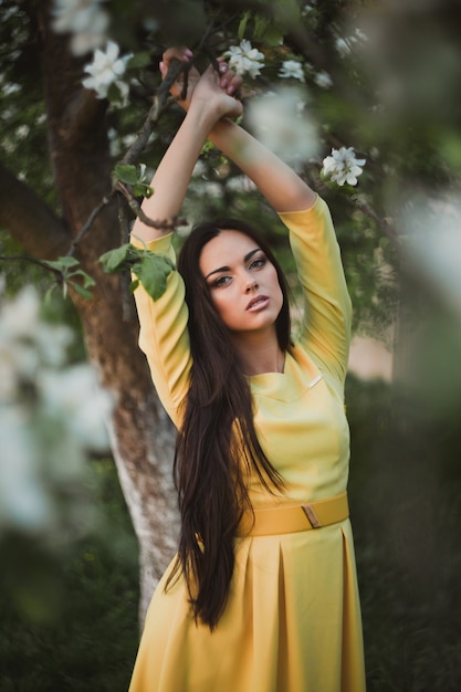 Stijlvolle zelfverzekerde brunette onder boom