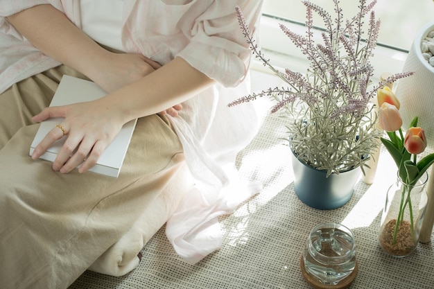 Photo still at home concept with asian woman reading book in her living room