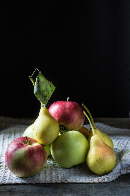 Still life of apples and pears on the table. Autumn mood.