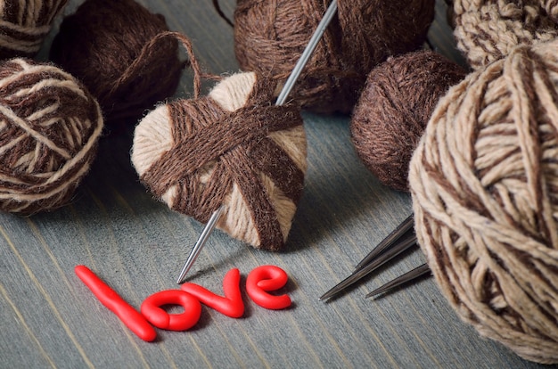 Still life of balls of yarn and the word love