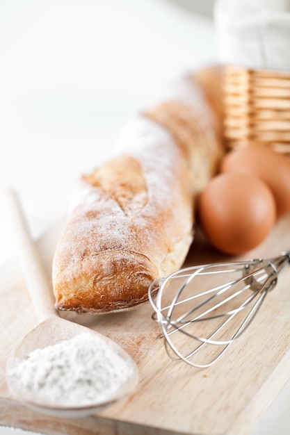 Still life of bread, flour, eggs and kitchen utensil