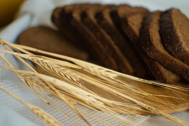 Still life of cereal spikelets and sliced bread