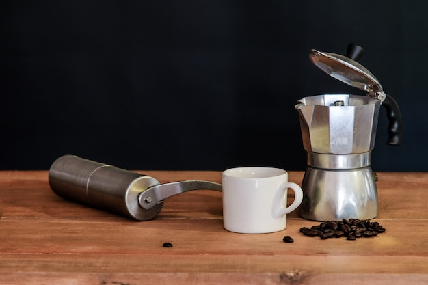 Still life coffee maker and cup on table.