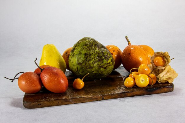 still life of exotic peruvian fruits cherimoya and uchuva aguaymanto  uvilla granadilla guava tree tomato