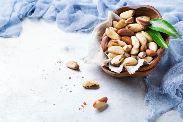 Still life food and drink heathy nutrition concept Portion of organic healthy brazil nuts on a rustic table selenium source Copy space background