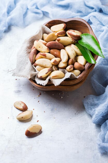 Still life food and drink heathy nutrition concept Portion of organic healthy brazil nuts on a rustic table selenium source Copy space background