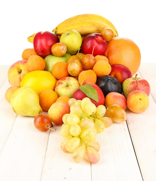 Still life of fruit on wooden table isolated on white