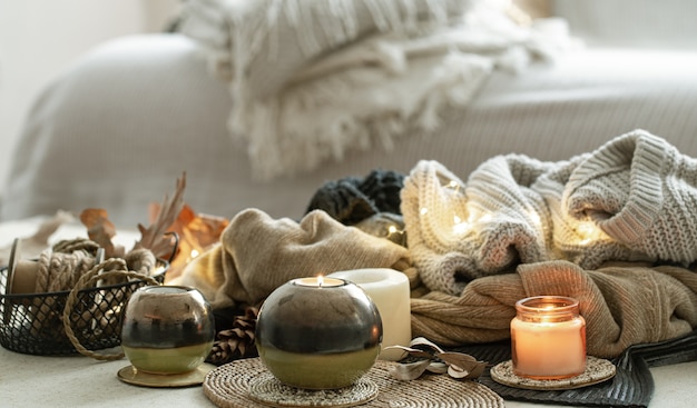 Still life of home decor details, candles, rope and warm clothes