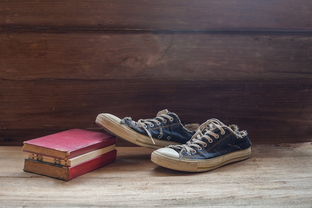 still life old shoes and old text book on wood