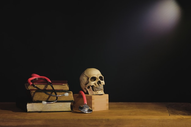 Photo still life painting photography with human skull on text book.