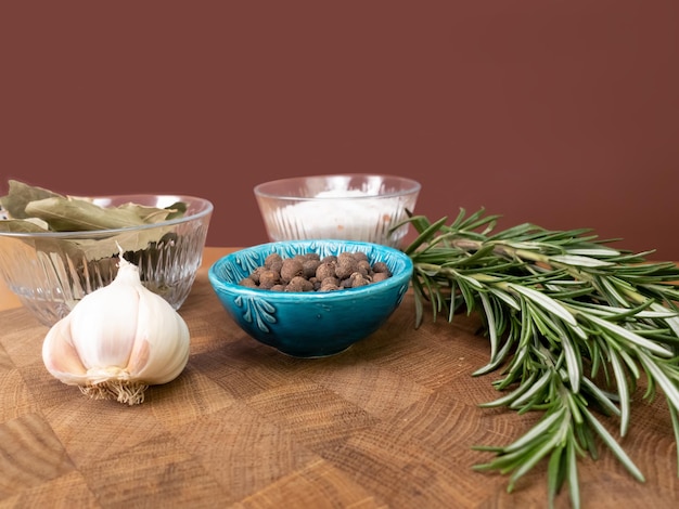 Still life photo with  spices for meat rosemary, garlic, pepper, salt.Photo with depth of field blur