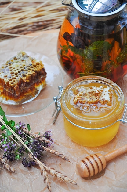 Still life sweet honey, honeycomb and herbal tea