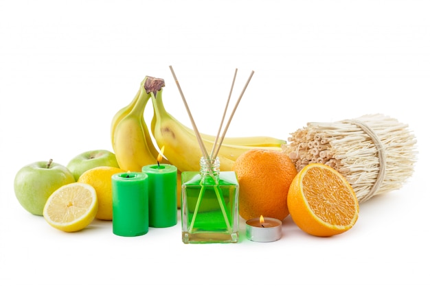 Still life of tropical fruits, essential oils and aroma diffuser.