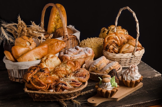 Still life of a varied assortment of breads on a black wall