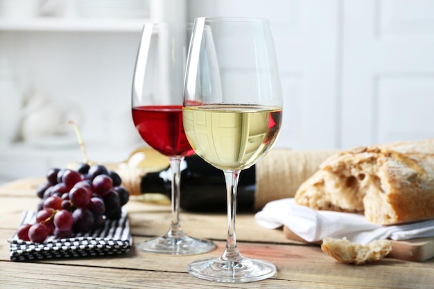 Still life of wine and bread on light background