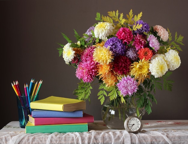 Still life with autumn bouquet and books. 