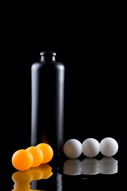 Still life with a bottle, balls and reflection.