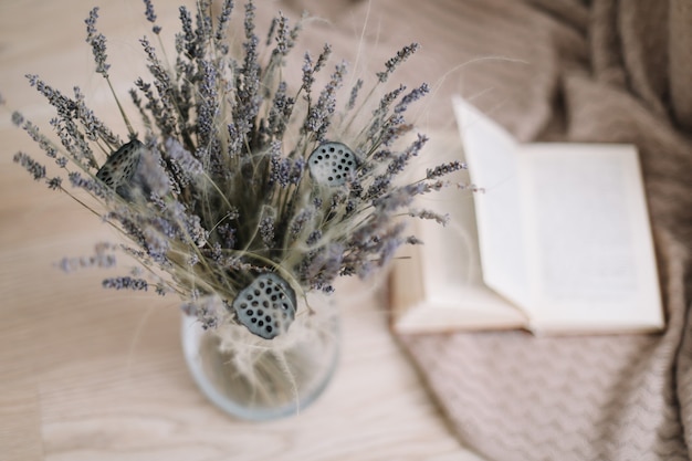 Still life with a bouquet of lavender and a book on wooden background