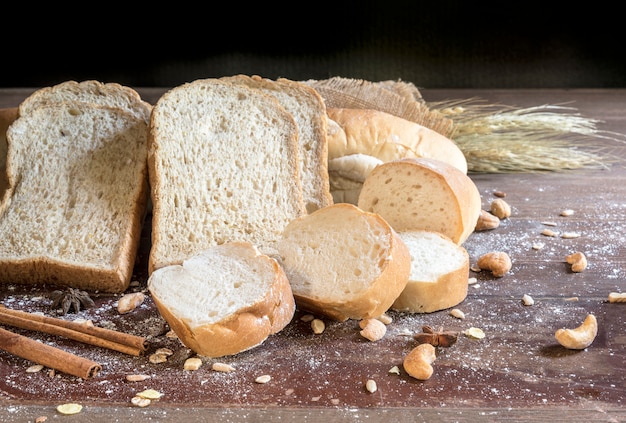 still life with bread and wheat on wooden table