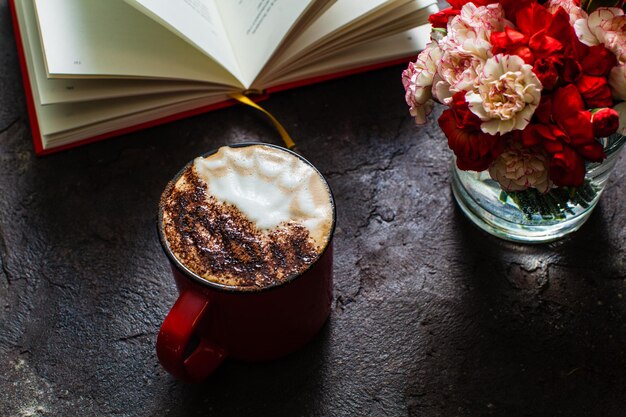 Still life with cappuccino cup or cocoa mug and red book or planner