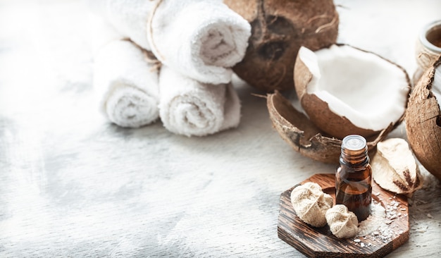 still life with coconut oil in a bottle and fresh coconut