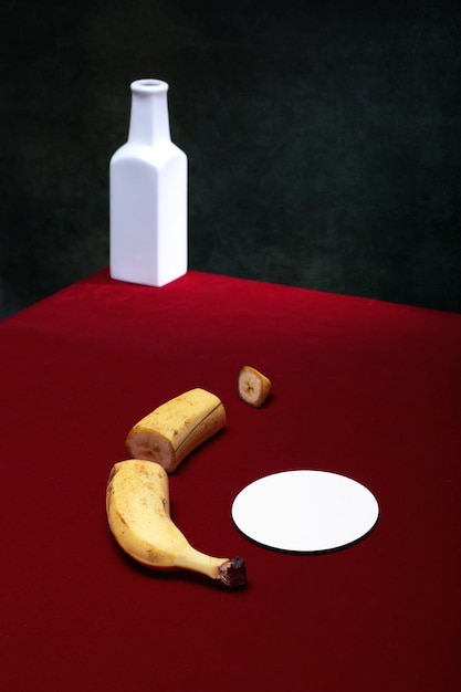 Still life with a cut banana on a red table