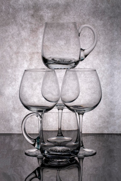 Photo still life with empty glass goblets on a gray background