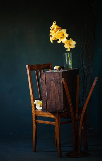 Still life with flowers and old vintage furniture in dark room