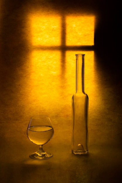 Still life with glass objects on a window background