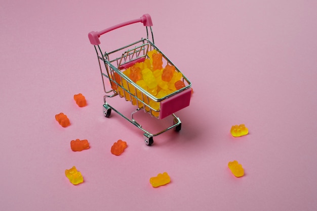 Photo still life with gummy bears in shopping cart