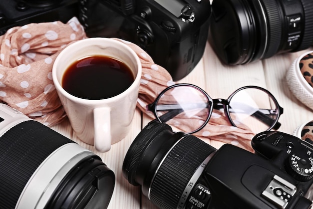 Photo still life with modern cameras on wooden table closeup