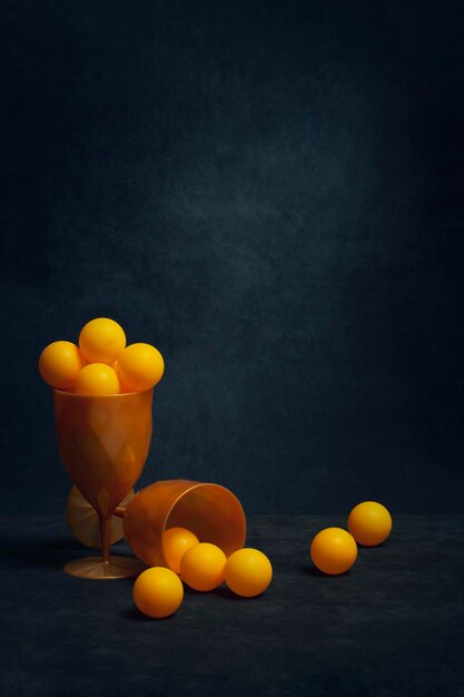 Still life with orange balls in glasses