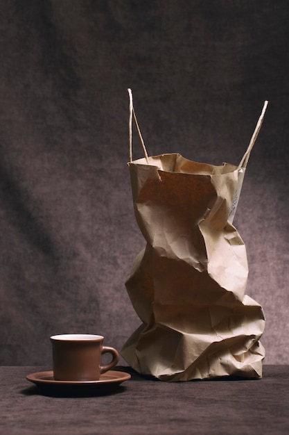 Still life with a paper bag and a coffee cup