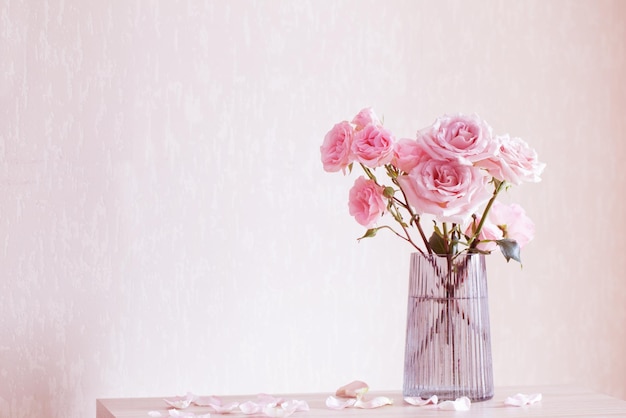 Still life with pink roses in glass vase