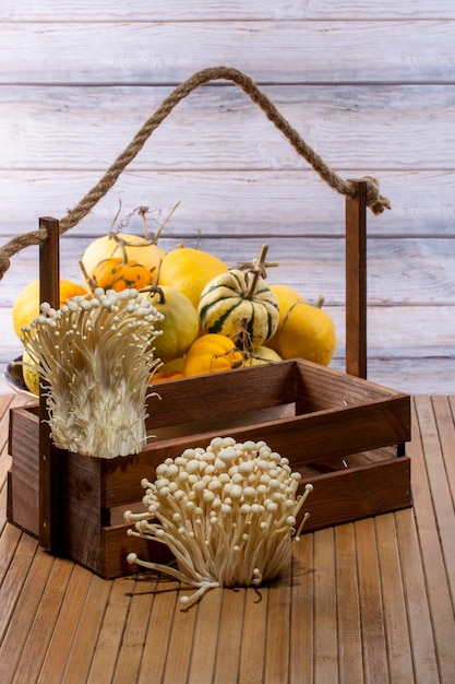 Still life with pumpkins, mushrooms and a wooden box