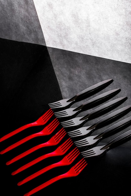 Photo still life with red and black forks