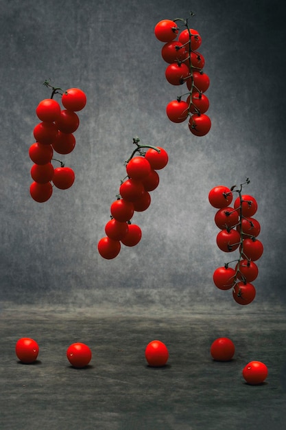 Photo still life with red ripe tomatoes on a branch