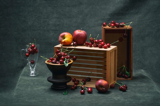 Still life with ripe apples and red cherries