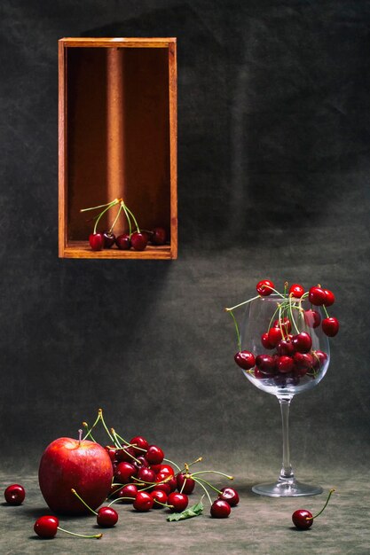 Photo still life with ripe apples and red cherries